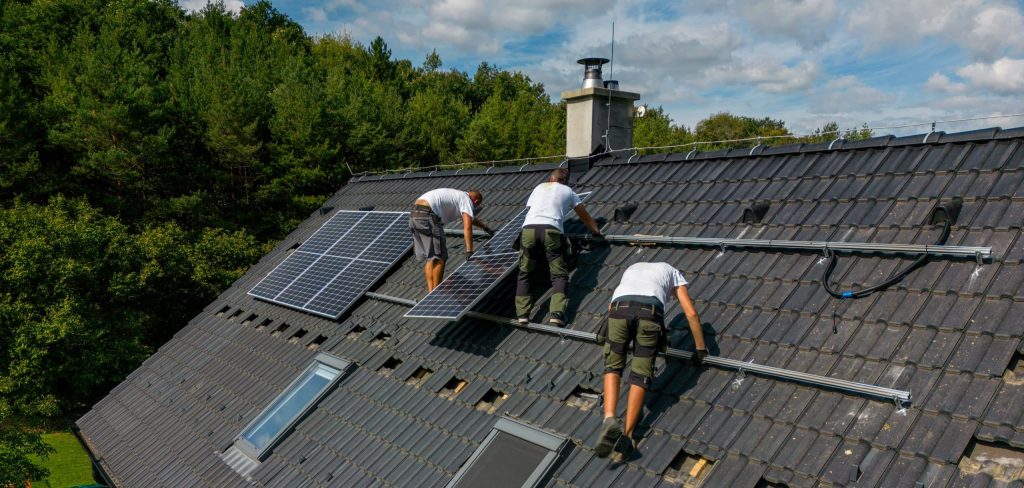 Men worker installing solar photovoltaic panels on roof, alternative energy, saving resources and sustainable lifestyle concept.
