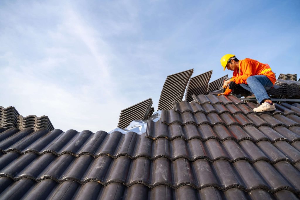 A roofer is installing a concrete roof on new roofs with Concret
